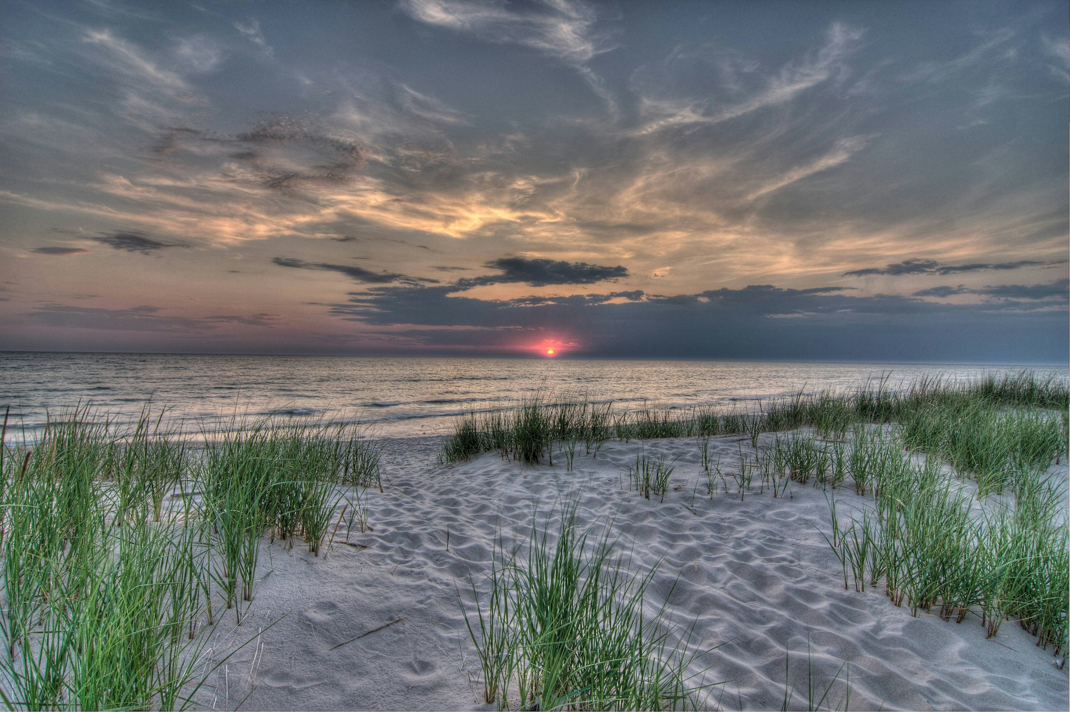 Sunset over the sand dunes and shoreline of Lake Michigan